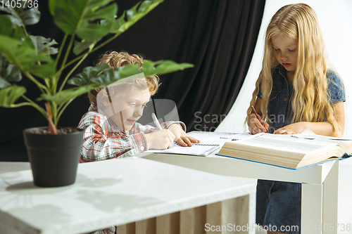 Image of Boy and girl preparing for school after a long summer break. Back to school.