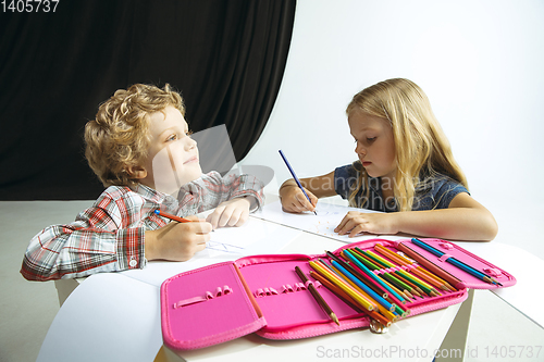 Image of Boy and girl preparing for school after a long summer break. Back to school.