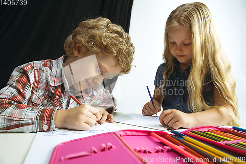 Image of Boy and girl preparing for school after a long summer break. Back to school.