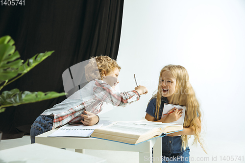 Image of Boy and girl preparing for school after a long summer break. Back to school.