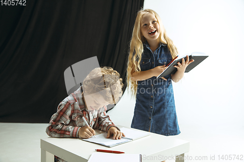 Image of Boy and girl preparing for school after a long summer break. Back to school.