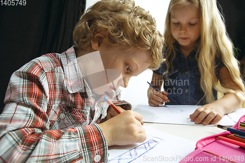 Image of Boy and girl preparing for school after a long summer break. Back to school.