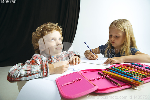 Image of Boy and girl preparing for school after a long summer break. Back to school.