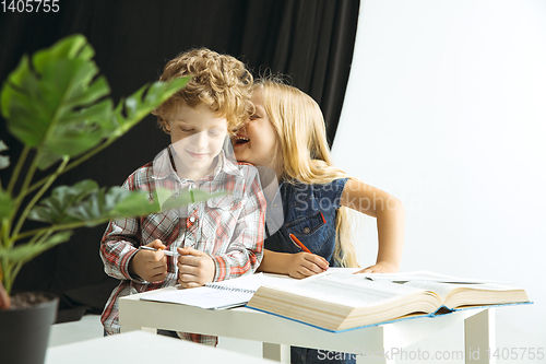 Image of Boy and girl preparing for school after a long summer break. Back to school.