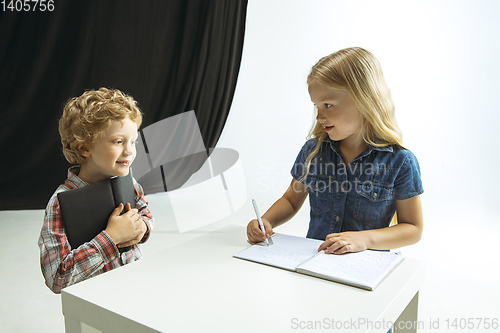 Image of Boy and girl preparing for school after a long summer break. Back to school.