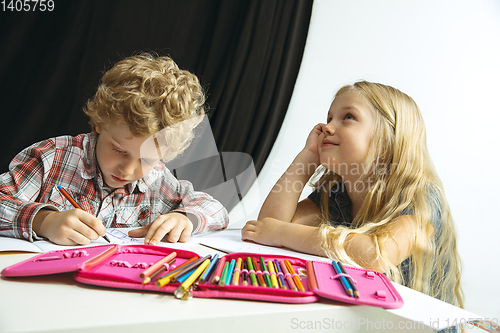 Image of Boy and girl preparing for school after a long summer break. Back to school.