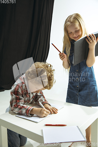 Image of Boy and girl preparing for school after a long summer break. Back to school.