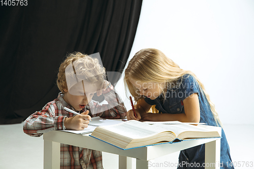 Image of Boy and girl preparing for school after a long summer break. Back to school.