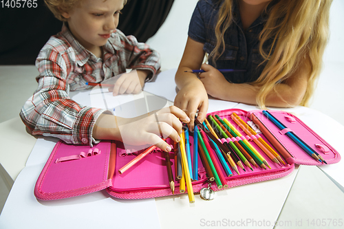 Image of Boy and girl preparing for school after a long summer break. Back to school.