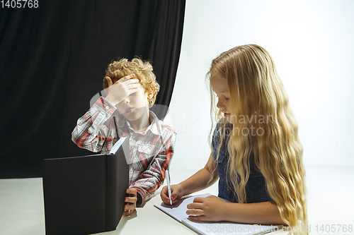 Image of Boy and girl preparing for school after a long summer break. Back to school.