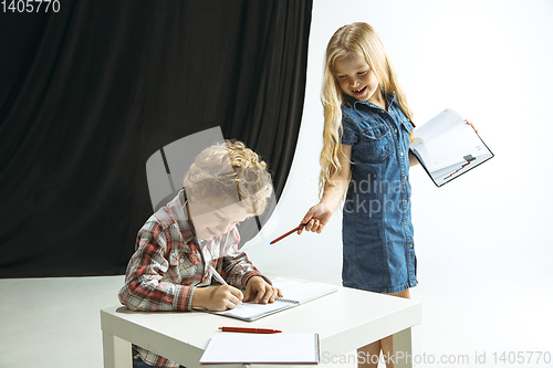 Image of Boy and girl preparing for school after a long summer break. Back to school.