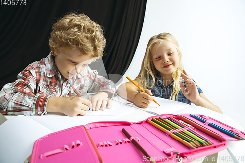 Image of Boy and girl preparing for school after a long summer break. Back to school.