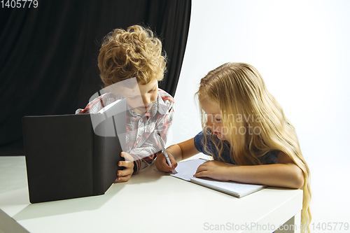 Image of Boy and girl preparing for school after a long summer break. Back to school.