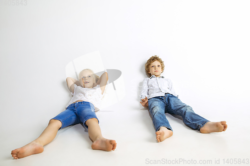 Image of Boy and girl playing together on white studio background