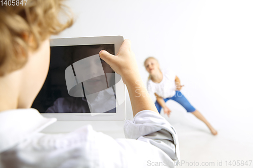 Image of Boy and girl playing together on white studio background