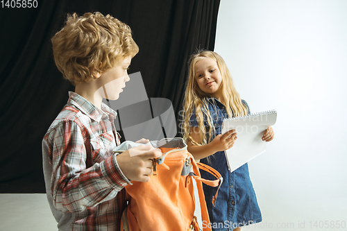 Image of Boy and girl preparing for school after a long summer break. Back to school.