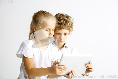 Image of Boy and girl playing together on white studio background