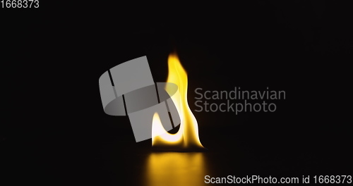 Image of Fire dancing against dark background 120fps slow motion loopable footage