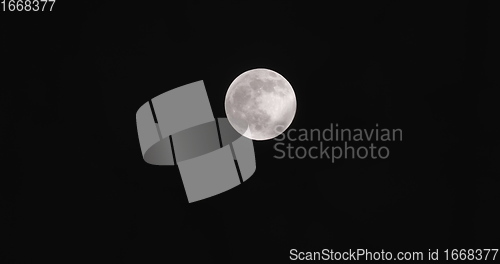 Image of Full moon with clouds moving in front of it