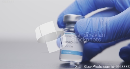 Image of Vaccine in human hands closeup footage