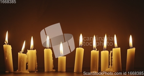 Image of Candles glowing against dark background