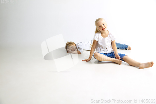 Image of Boy and girl playing together on white studio background