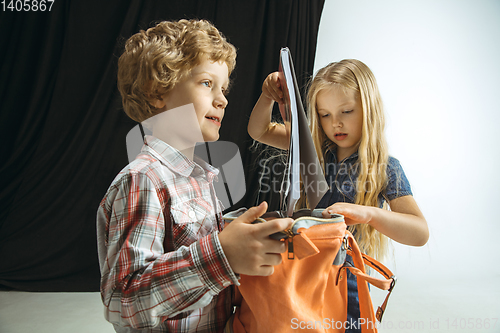 Image of Boy and girl preparing for school after a long summer break. Back to school.