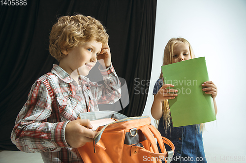 Image of Boy and girl preparing for school after a long summer break. Back to school.