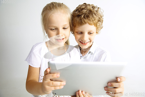 Image of Boy and girl playing together on white studio background