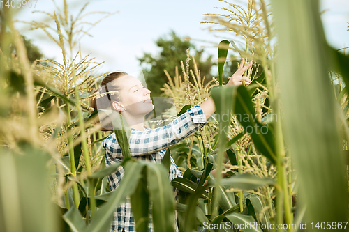 Image of Young farmer working at his garden in sunny day