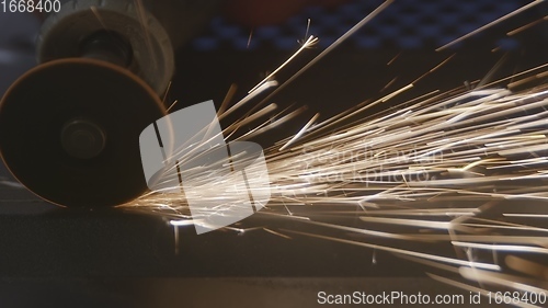 Image of Steel cutter with sparks while cutting steel bar