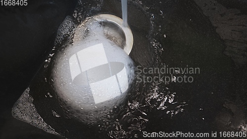 Image of Foam and water whirling in wash basin