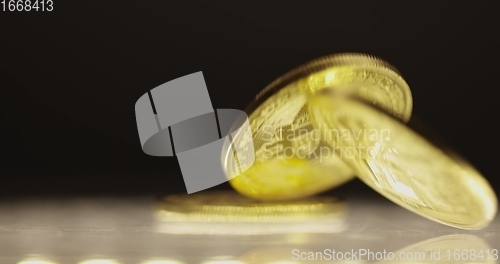 Image of Shiny bitcoin falling down on steel surface slow motion 120 fps