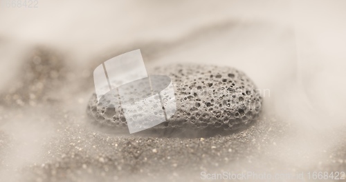 Image of Smoke whirling around small meteorite stone