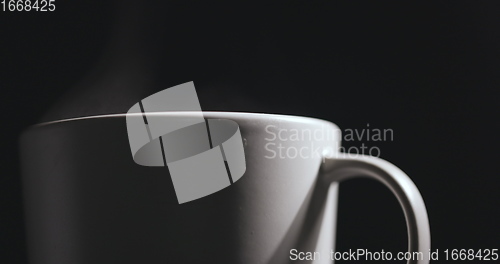 Image of Vapor rising from hot mug closeup footage