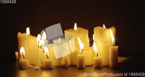 Image of Candles glowing against dark background