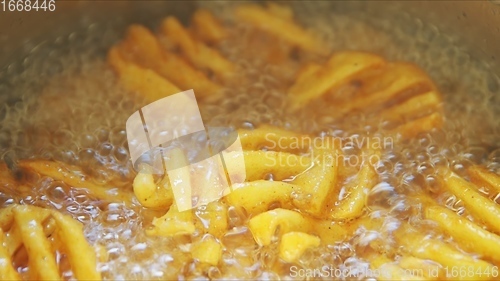 Image of French fries boiling in sunflower oil