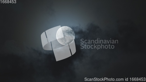 Image of Full moon against cloudy night sky