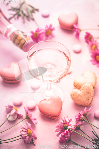 Image of Happy Mothers Day - sweet macarons in heart shape and glass of rose sparkling wine