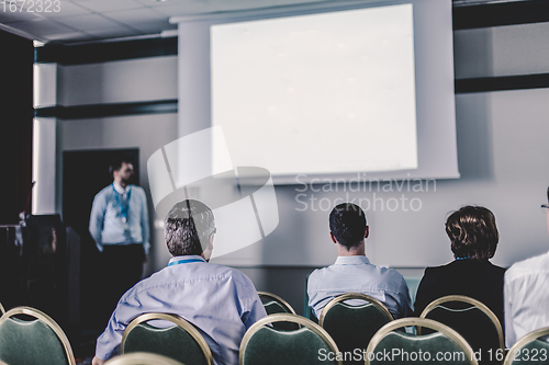 Image of Audience in lecture hall participating at business conference.