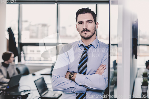 Image of Team leader with coworkers working in office.