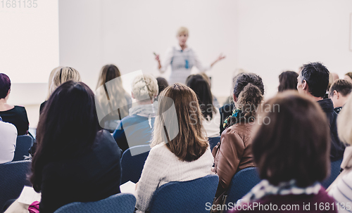 Image of Woman giving presentation on business conference.