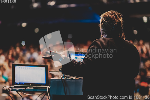 Image of Public speaker giving talk at Business Event.