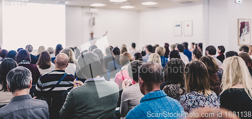 Image of Woman giving interactive motivational speech at entrepreneurship workshop.