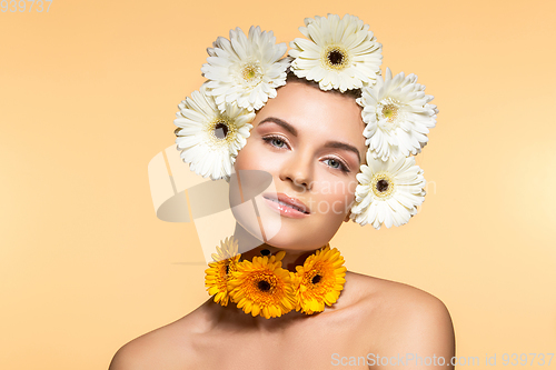 Image of beautiful girl with white and yellow flowers