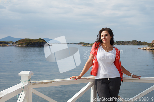 Image of Young woman against view on norwegian fjords