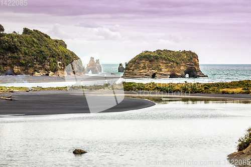 Image of sea shore rocks and mount Taranaki, New Zealand