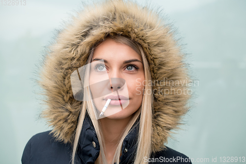 Image of portrait of young blonde girl with cigarette in the mouth