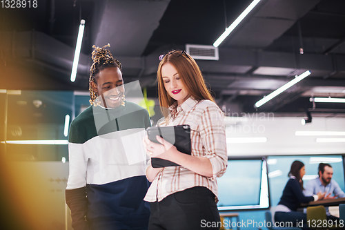 Image of multiethnic business couple using a tablet computer