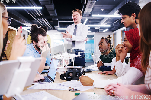 Image of multiethnic business team learning about drone technology